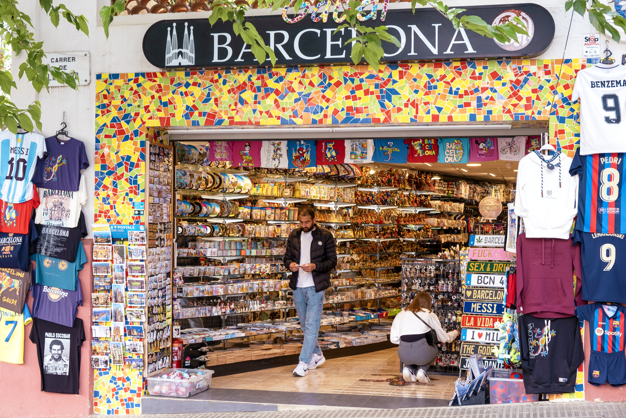 Barcelona, Spain - Traditional souvenir shop in Barcelona, Spain with tourists looking for gifts