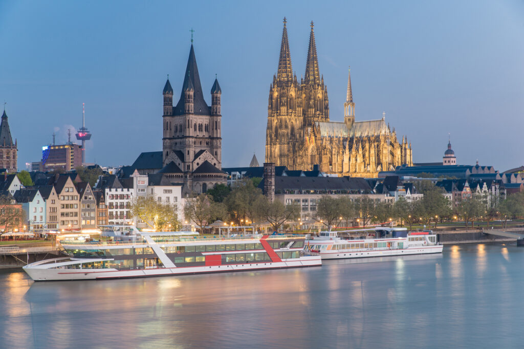 Best Christmas Market River Cruise 2024 with Festive European Markets and Scenic River Views. Aerial view over the Rhine River with cruise ship in Cologne, Germany