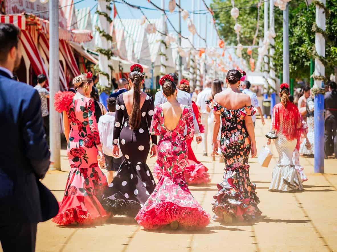 Seville, Spain - April 26, 2023 : Women in colorful flamenco dresses at the festive Seville Fair. Colorful flamenco dresses and horse parades during Feria de Abril de Sevilla 2025 celebrations. Seville April Fair 2025.