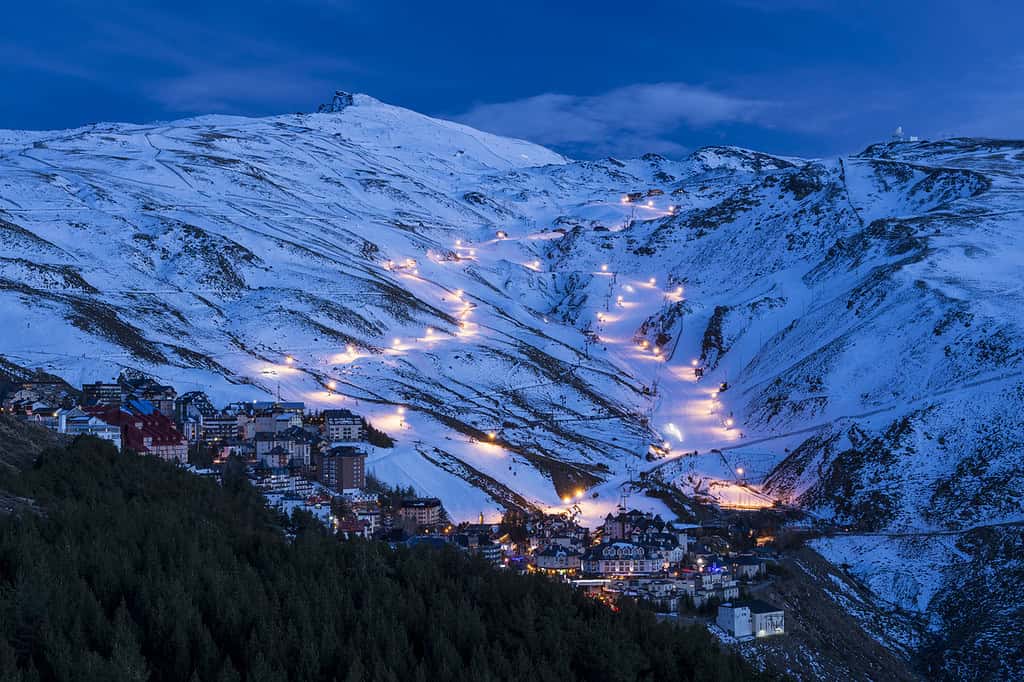 Lights at night in snowy hills in Sierra Nevada. Pradollano area, Sierra Nevada National Park, Granada, Andalusia, Spain. - Best Day Trips from Granada