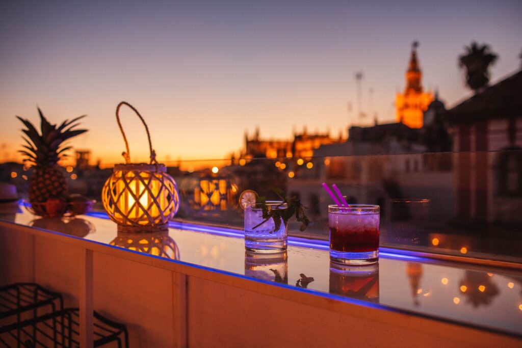 Rooftop pool with cathedral views and loungers at Halo Boutique Hotel Sevilla