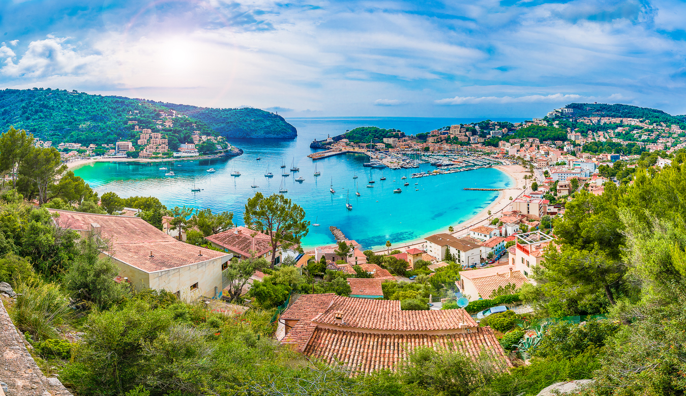 Panoramic view of Porte de Soller, Palma Mallorca, Spain - Coastal view of Mallorca Spain with cliffs, turquoise sea, and terracotta rooftops