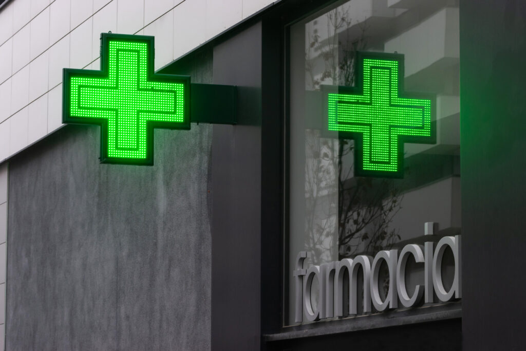 Green pharmacy cross outside a pharmacy in Spain