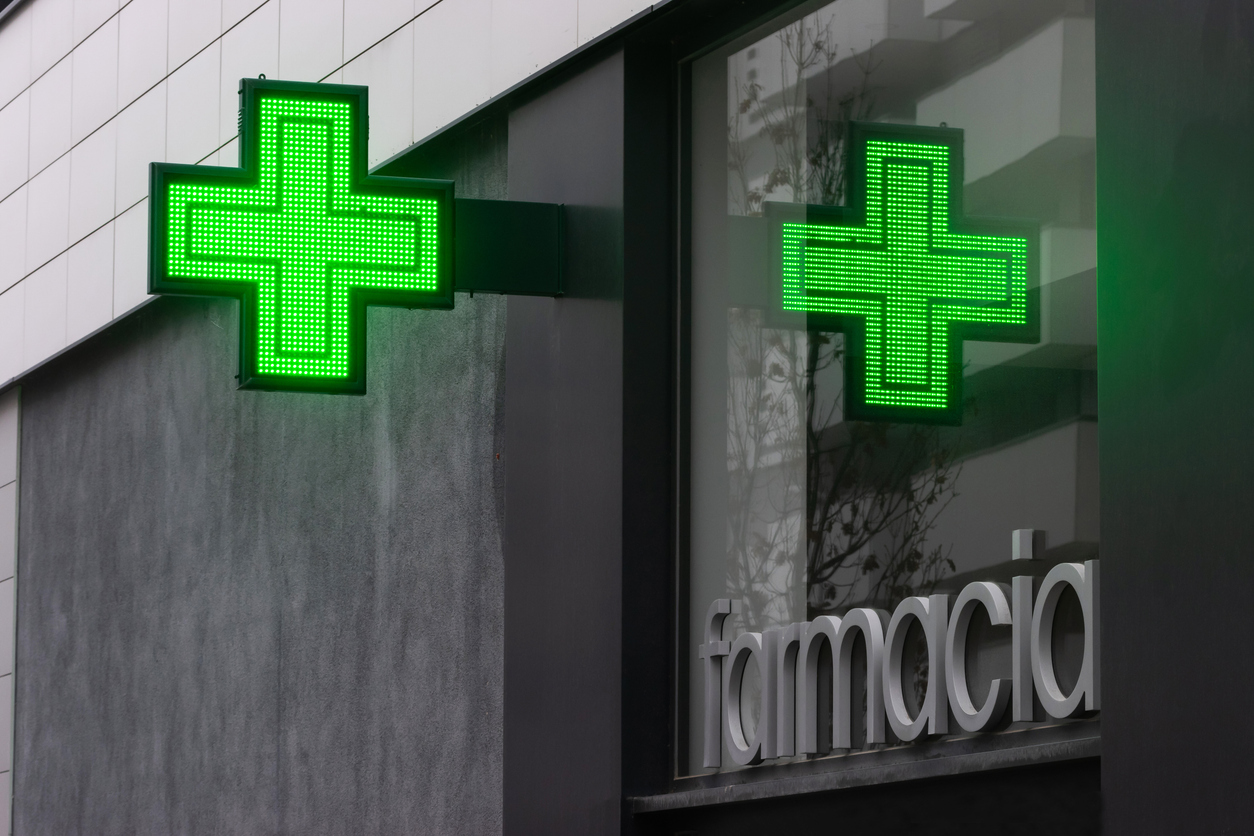 Green pharmacy cross outside a pharmacy in Spain